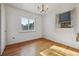 Cozy bedroom with hardwood floors, window AC unit, and natural light at 2105 S Irving St, Denver, CO 80219