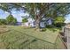 Charming house on a green lawn, shaded by a large, mature tree at 2105 S Irving St, Denver, CO 80219