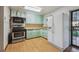 Functional kitchen featuring essential appliances and plenty of cabinet space at 2105 S Irving St, Denver, CO 80219