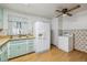 Charming kitchen featuring vintage-style cabinets, and a convenient laundry area at 2105 S Irving St, Denver, CO 80219