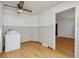 Room with laundry hookups, vinyl floor, floral wallpaper and ceiling fan at 2105 S Irving St, Denver, CO 80219