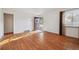 Light-filled living room with hardwood floors, a front door, and a window at 2105 S Irving St, Denver, CO 80219