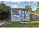 Backyard shed with blue trim, useful for extra storage at 2105 S Irving St, Denver, CO 80219