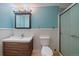 Well-lit bathroom featuring a sleek wood vanity, medicine cabinet, and glass-enclosed shower at 11539 Depew Ct, Westminster, CO 80020