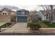 Charming two-story home with blue siding, a well-manicured lawn, and an attached two-car garage at 11539 Depew Ct, Westminster, CO 80020