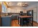 Well-lit kitchen with stainless steel appliances, ample counter space, a center island, and wood floors at 11539 Depew Ct, Westminster, CO 80020