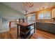 Well-lit kitchen with stainless steel appliances, ample counter space, a center island, and wood floors at 11539 Depew Ct, Westminster, CO 80020