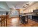 Modern kitchen with stainless steel appliances, a center island with bar seating, and stylish lighting at 11539 Depew Ct, Westminster, CO 80020