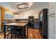 Well-lit kitchen with stainless steel appliances, ample counter space, a center island, and wood floors at 11539 Depew Ct, Westminster, CO 80020