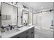 Modern bathroom with double sinks, sleek fixtures, and a glass-enclosed shower at 2393 Yosemite St, Denver, CO 80238