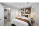Warm bedroom with floral art, lamps on bedside tables, and access to a personal gym for convenient workouts at 2393 Yosemite St, Denver, CO 80238