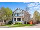 Charming two-story home with blue siding, a cozy front porch, and a well-maintained lawn at 2393 Yosemite St, Denver, CO 80238