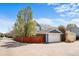 Detached garage with ample space for vehicles and storage, complemented by a beautifully fenced yard for privacy at 2393 Yosemite St, Denver, CO 80238