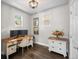 Cozy home office featuring a wooden desk, comfortable chair, and natural light from the windows at 2393 Yosemite St, Denver, CO 80238
