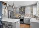 Modern kitchen with gray cabinets, stainless steel appliances, and a sleek island with bar stools at 2393 Yosemite St, Denver, CO 80238