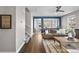 Open concept living room with hardwood floors, neutral colors, and seamless transition to dining area at 2393 Yosemite St, Denver, CO 80238