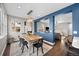 Open concept dining and living room space, with hardwood floors and bright natural light at 2393 Yosemite St, Denver, CO 80238