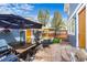 Inviting outdoor patio ideal for dining, featuring an outdoor grill, comfortable seating, and beautiful landscaping at 2393 Yosemite St, Denver, CO 80238