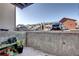 Small patio with garden and view of the complex's exterior and parking at 10150 E Virginia Ave # 19-102, Denver, CO 80247