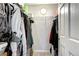 Open closet with clothes hanging on racks and bags on the floor at 10150 E Virginia Ave # 19-102, Denver, CO 80247