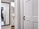 Hallway leads to a bathroom with a white vanity and a mirror hanging on the wall at 10150 E Virginia Ave # 19-102, Denver, CO 80247