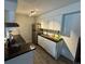 Bright kitchen features white cabinets, granite counters, stainless steel appliances, and modern backsplash at 10150 E Virginia Ave # 19-102, Denver, CO 80247