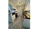 Updated kitchen features a stainless steel oven, black countertops, white cabinets, and hardwood-style floors at 10150 E Virginia Ave # 19-102, Denver, CO 80247