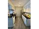 This modern kitchen is updated with white cabinets, stainless appliances, and black countertop at 10150 E Virginia Ave # 19-102, Denver, CO 80247