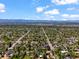 An aerial view of a suburban neighborhood with snow capped mountains in the distance at 4456 S Washington St, Englewood, CO 80113