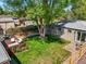 Expansive backyard featuring a lush lawn, mature trees, and a wooden deck perfect for outdoor entertaining at 4456 S Washington St, Englewood, CO 80113