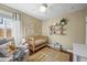 Cozy Bedroom featuring a wooden crib, comfortable armchair, and colorful decor with ample natural light at 4456 S Washington St, Englewood, CO 80113