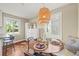 Charming dining area featuring a round table with seating and a unique woven pendant light fixture at 4456 S Washington St, Englewood, CO 80113