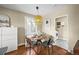 Cozy dining area with hardwood floors and built-in bench seating with laundry through doorway at 4456 S Washington St, Englewood, CO 80113