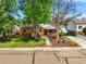 Charming brick home with a well-maintained lawn and mature trees at 4456 S Washington St, Englewood, CO 80113