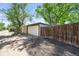 Detached garage with a white door and a wooden fence at 4456 S Washington St, Englewood, CO 80113