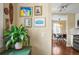 Hallway with hardwood floors and decorated with wall art. Opens into the kitchen and dining areas at 4456 S Washington St, Englewood, CO 80113