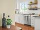 Stylish kitchen with modern appliances, ample storage, and floating shelves for displaying decorative items at 4456 S Washington St, Englewood, CO 80113