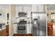 This kitchen features stainless steel appliances, white cabinets and open layout design for meal preparation and entertaining at 4456 S Washington St, Englewood, CO 80113