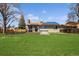 Spacious backyard with large lawn, wooden deck, hot tub, and solar panels at 9532 W Walden Ave, Littleton, CO 80128