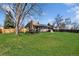 Spacious backyard with lawn, wooden deck, hot tub, and solar panels on roof at 9532 W Walden Ave, Littleton, CO 80128