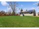 Spacious backyard with large lawn, wooden deck, hot tub, and solar panels on roof at 9532 W Walden Ave, Littleton, CO 80128