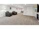 Finished basement area with carpet, recessed lighting, leather seating, and a small table at 9532 W Walden Ave, Littleton, CO 80128