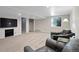 Finished basement featuring carpet, recessed lighting, leather chairs and a television at 9532 W Walden Ave, Littleton, CO 80128