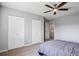 Bright, neutral bedroom featuring a ceiling fan, carpet, and a large double door closet at 9532 W Walden Ave, Littleton, CO 80128
