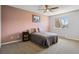 Comfortable bedroom with neutral carpet, a queen bed, and a window offering natural light at 9532 W Walden Ave, Littleton, CO 80128