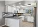 Bright, updated kitchen with stainless steel appliances, sleek countertops, white cabinets, and modern fixtures at 9532 W Walden Ave, Littleton, CO 80128