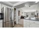 Modern kitchen with stainless steel appliances and views through to the home's beautifully decorated living room at 9532 W Walden Ave, Littleton, CO 80128
