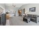 Spacious living room with fireplace, neutral paint, and an open layout flowing into the kitchen area at 9532 W Walden Ave, Littleton, CO 80128