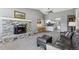 Open-concept living space with a fireplace and seamless access to the modern kitchen, creating a welcoming atmosphere at 9532 W Walden Ave, Littleton, CO 80128