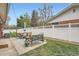 A cozy backyard patio with comfortable seating, a dining table, and a well-maintained lawn at 9580 W 12Th Pl, Lakewood, CO 80215